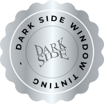 Silver circular badge with scalloped edges featuring the words "DARK SIDE WINDOW TINTING" around the border and the stylized "DARK SIDE" logo in the center.