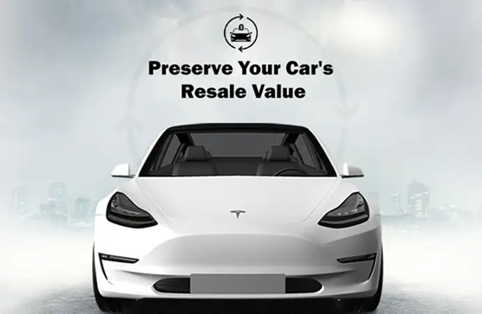 Front view of a white Tesla Model 3 with text above it that reads "Preserve Your Car's Resale Value" against a foggy cityscape background.