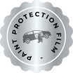 Circular silver badge with a scalloped edge featuring the words "PAINT PROTECTION FILM" and an icon of a person applying film to a car’s side. The design symbolizes automotive surface protection.