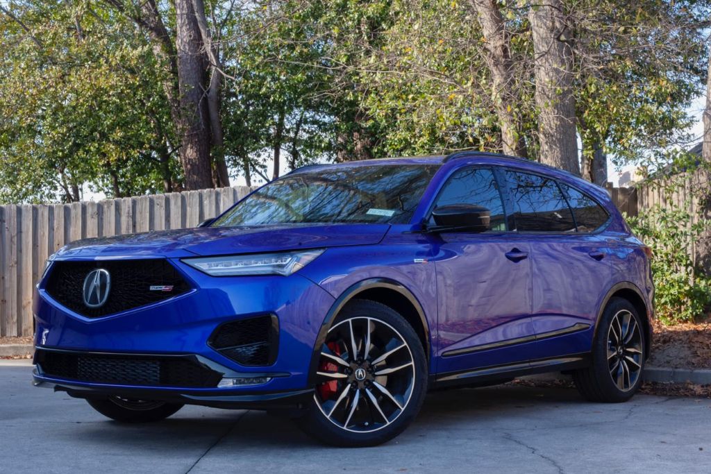 A blue SUV with tinted windows parked outdoors, showcasing a sleek and polished look after professional tinting. This image represents the result of investing in quality film and installation, which factors into the cost of window tinting for vehicles in Augusta, GA.