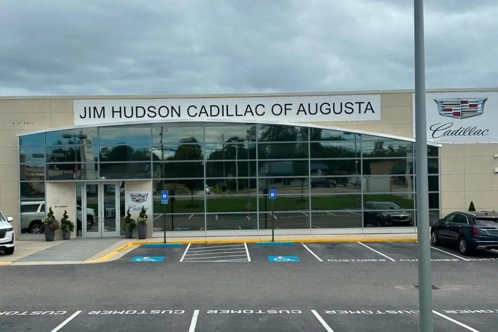 Jim Hudson Cadillac dealership with reflective commercial window tint on glass storefront
