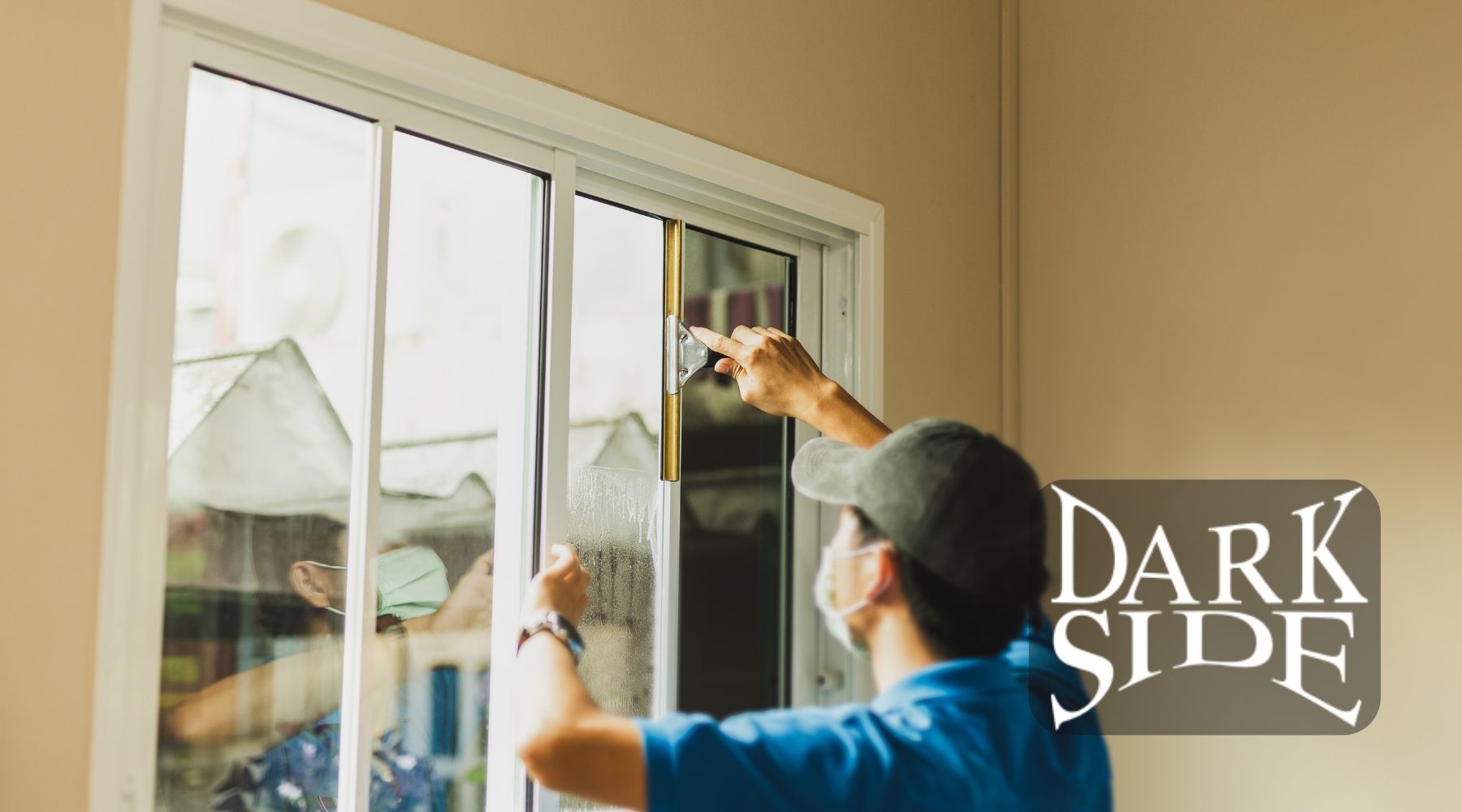 Technician installing security window film on a residential sliding glass window in Augusta GA
