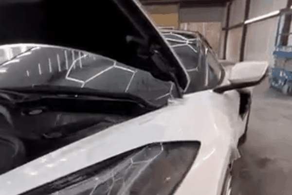 White vehicle with paint protection film installed near the front headlight and fender area