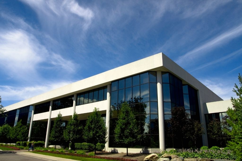 Modern commercial office building with large glass windows suitable for security window film.